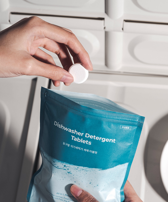 Person taking a tablet from DONGGUBAT Dishwasher Detergent Tablets 60 240g package.
