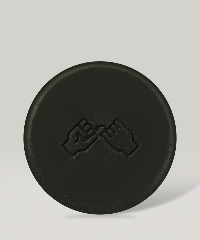 DONGGUBAT Field Ampoule Washing Bar Kelp Foam Cleansing product image featuring a black round cleansing bar with hand symbol.