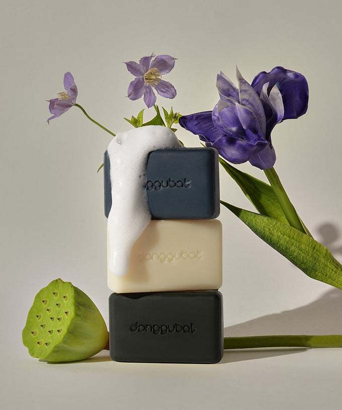 DONGGUBAT Field Blooming Perfume Shampoo Bar Repair 80g displayed with flowers and bubbles, showcasing a luxurious eco-friendly hair care product.