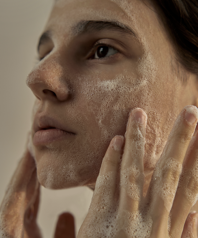 Woman washing face with DONGGUBAT Field Dream Soap Basil for clear skin