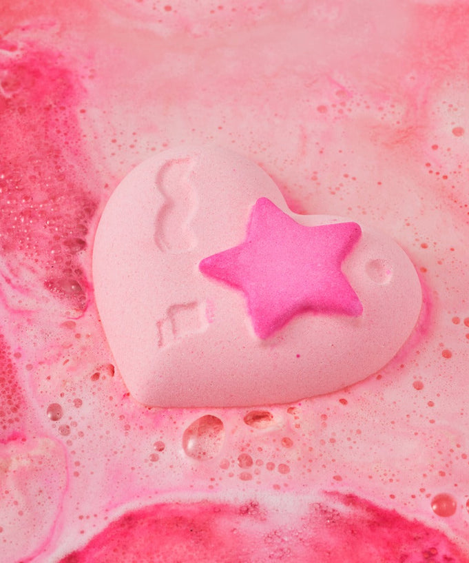 Heart-shaped bath bomb from DONGGUBAT Happy Moment Bath Bomb Set 2 pieces creating pink bubbles in water.