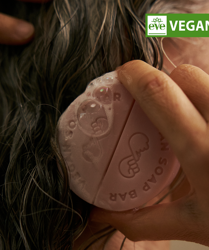 Using DONGGUBAT Vegan Shampoo Bar Dongbaek on wet hair for effective cleansing.