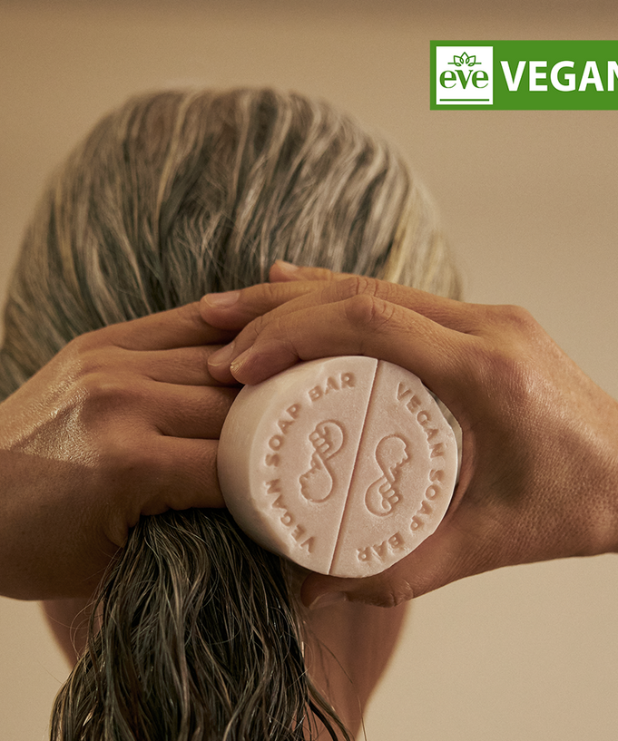 Person using DONGGUBAT Vegan Treatment Bar Dongbaek on wet hair, highlighting eco-friendly and vegan features.