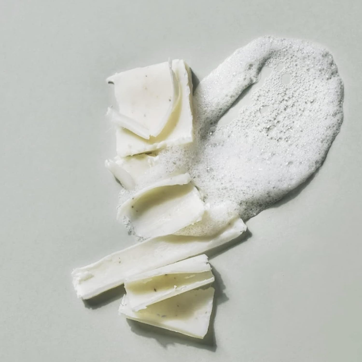 DONGGUBAT Correct Dishwashing Washing Bar 500g with foamy lather on a neutral background.