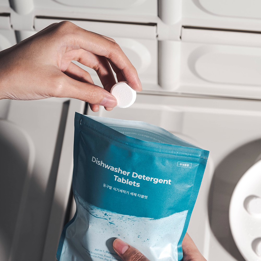 Person taking a tablet from DONGGUBAT Dishwasher Detergent Tablets 60 240g package.