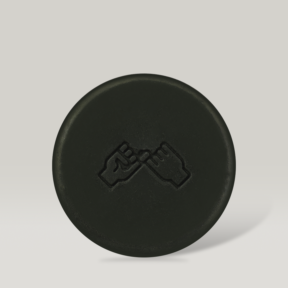 DONGGUBAT Field Ampoule Washing Bar Kelp Foam Cleansing product image featuring a black round cleansing bar with hand symbol.