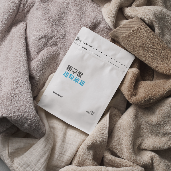 DONGGUBAT Laundry Detergent 70 Tablets packaging amidst soft towels