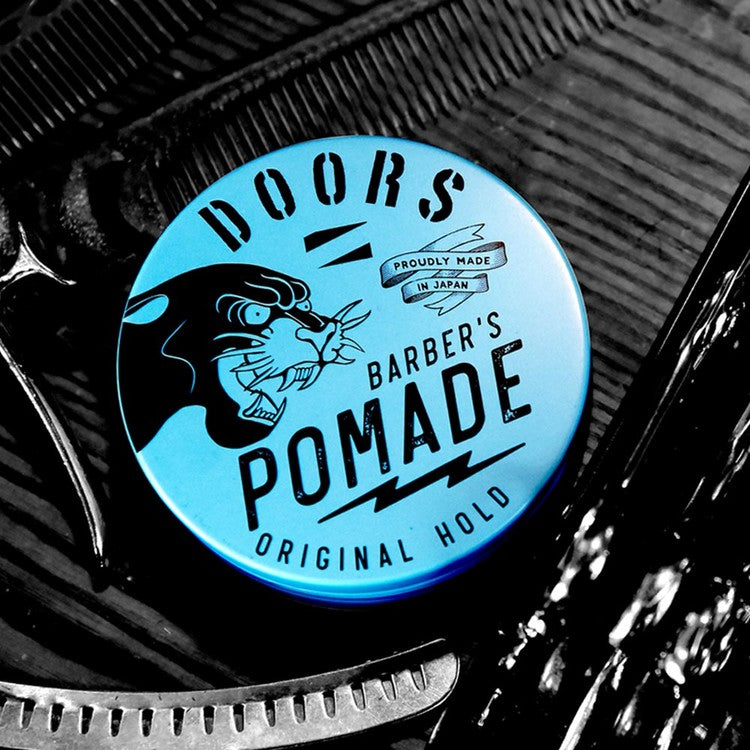 DOORS Original Pomade 120g - Gentleman Korea product shot of blue tin pomade with barber tools