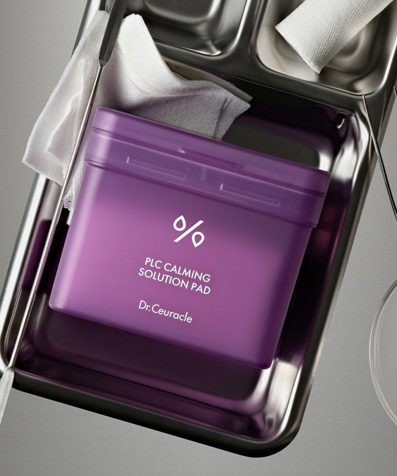 DR.CEURACLE PLC Calming Solution Pad 130 pads in purple packaging on a metal tray.