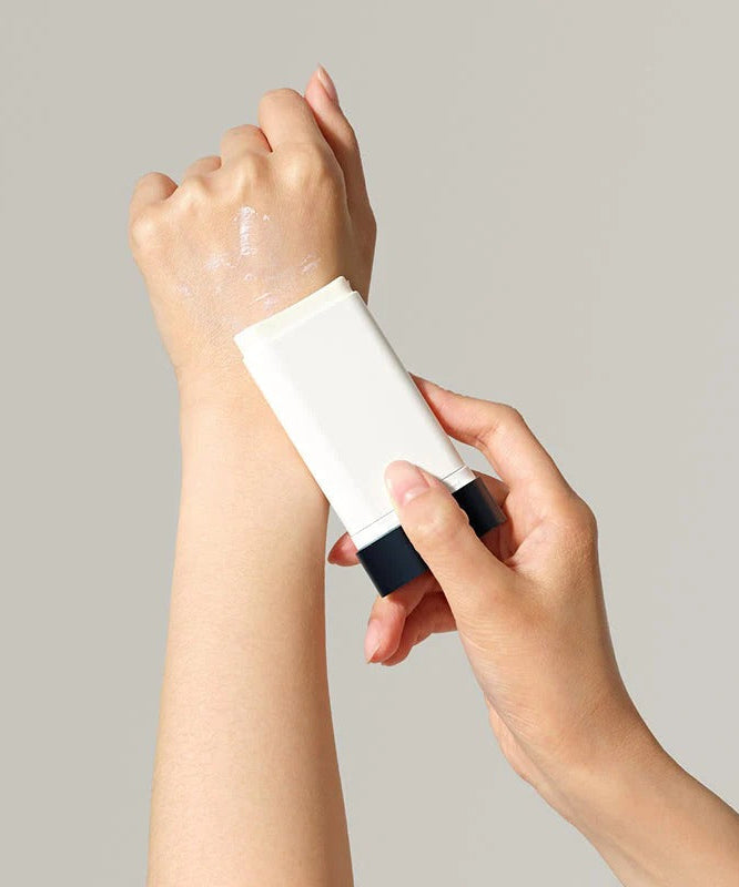 Applying DR.CEURACLE Pro Balance Comfort Sun Stick 18g on arm for sun protection