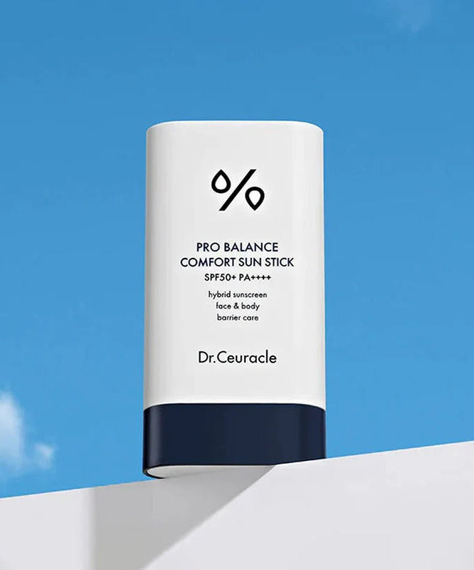 Image of DR.CEURACLE Pro Balance Comfort Sun Stick 18g against a blue sky background with packaging details visible.