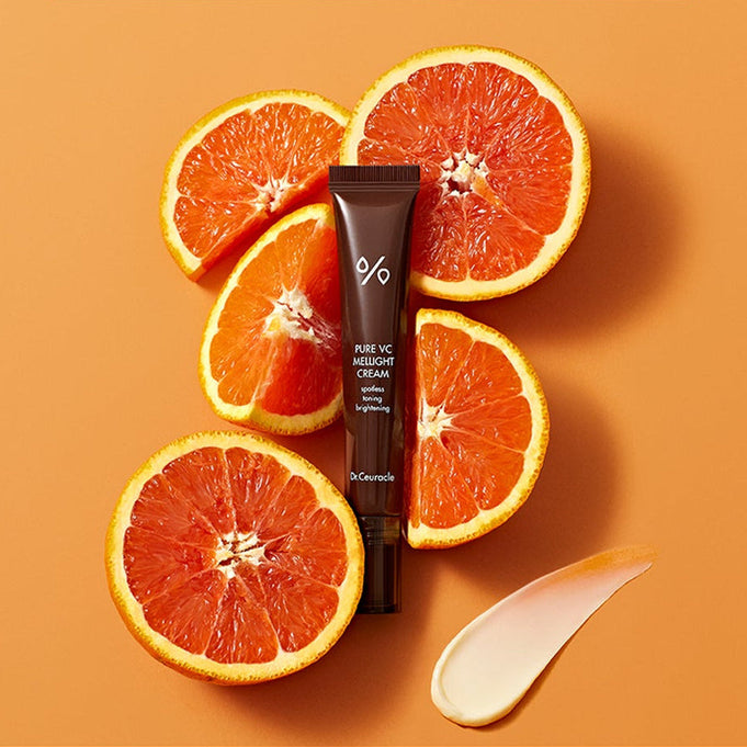 DR.CEURACLE Pure VC Melite Cream 20ml with fresh oranges on orange background, product packaging view.