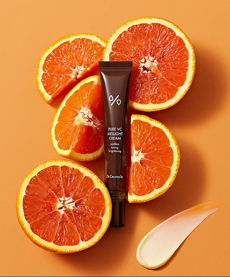 DR.CEURACLE Pure VC Melite Cream 20ml with fresh oranges on orange background, product packaging view.