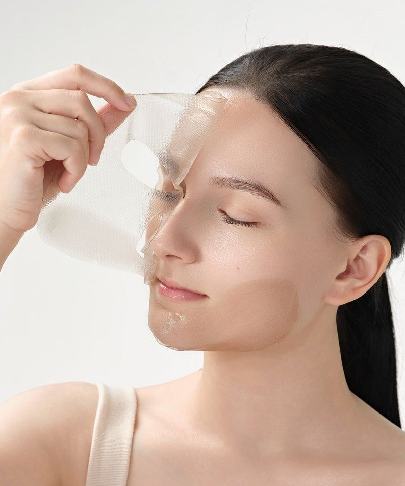 Woman applying DR.CEURACLE Vegan Kombucha Tea Essence-in-Gel Mask for skincare
