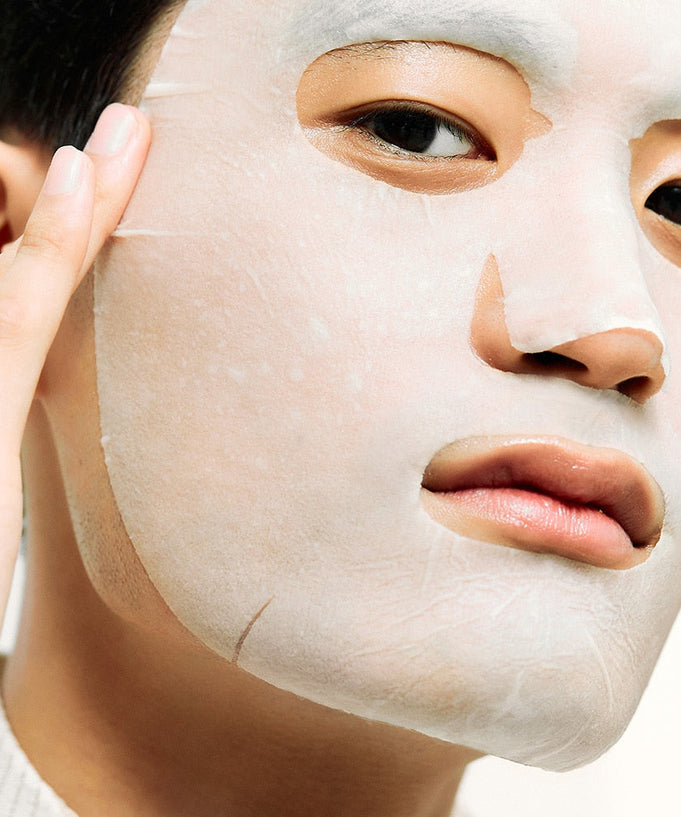Person applying DR.JART+ Ceramidin Skin Barrier Moisturizing Mask, hypoallergenic sheet mask with natural fibers and ceramides.