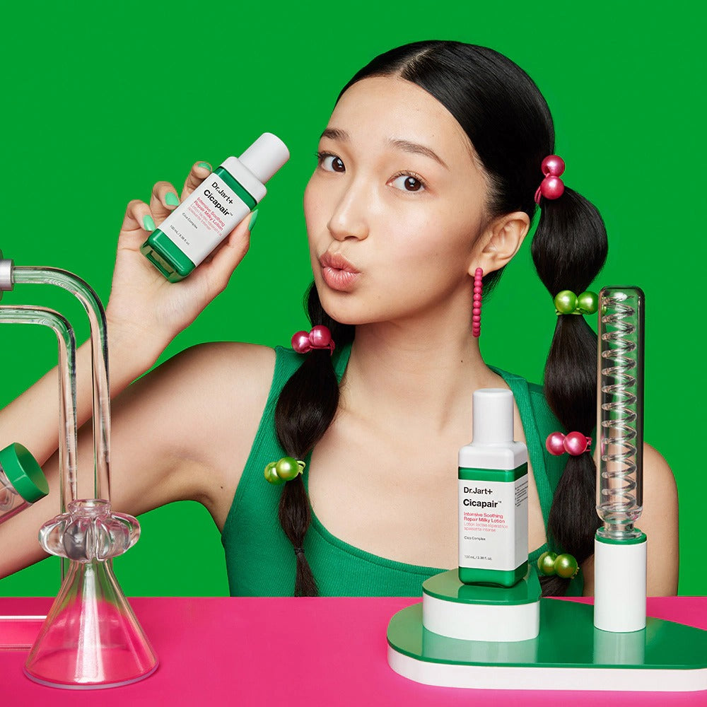 Woman holding DR.JART+ Cicapair Intensive Soothing Repair Milky Lotion 100ml in a vibrant lab setting