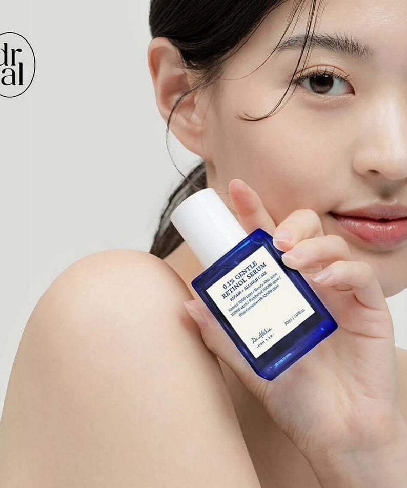 Person holding DR.ALTHEA 0.1% Gentle Retinol Serum 30ml bottle close to face