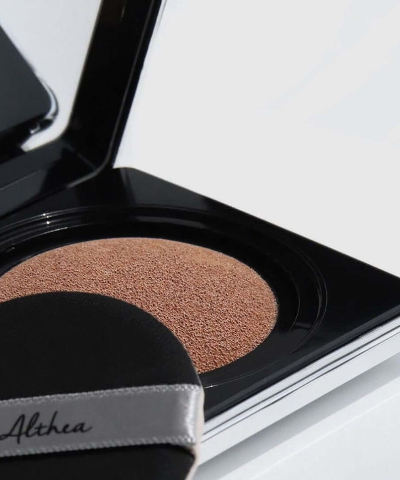 Close-up of DR.ALTHEA Aurora Cover Cushion 15g showing cushion texture and puff applicator in compact.
