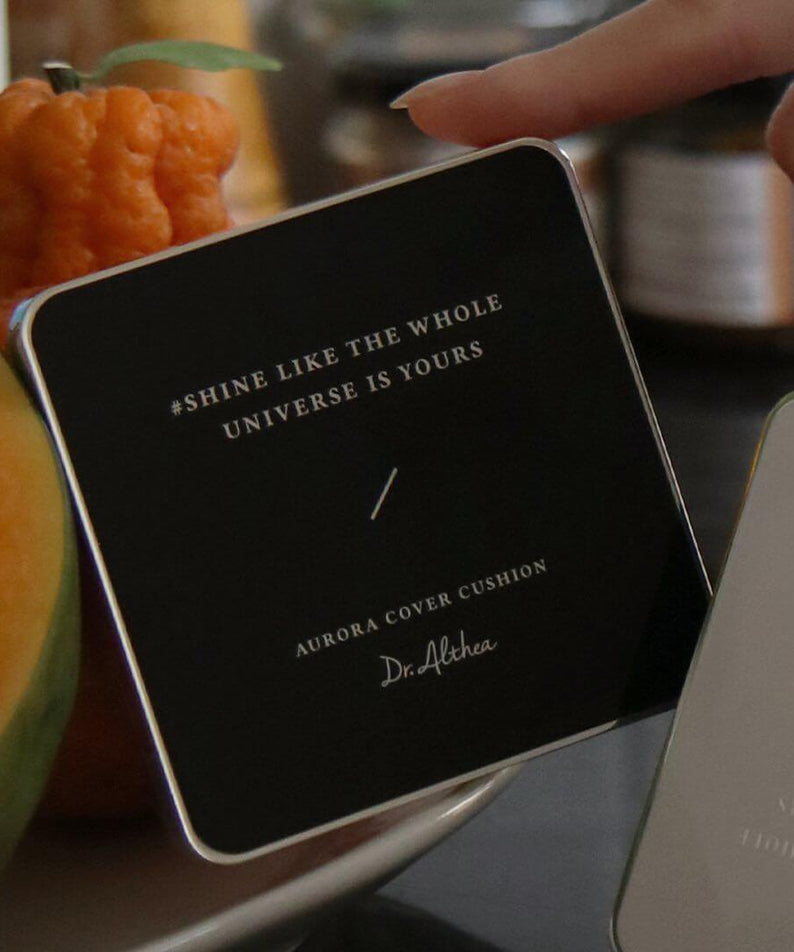 Close-up of DR.ALTHEA Aurora Cover Cushion Moisture 15g with inspirational quote in elegant packaging.
