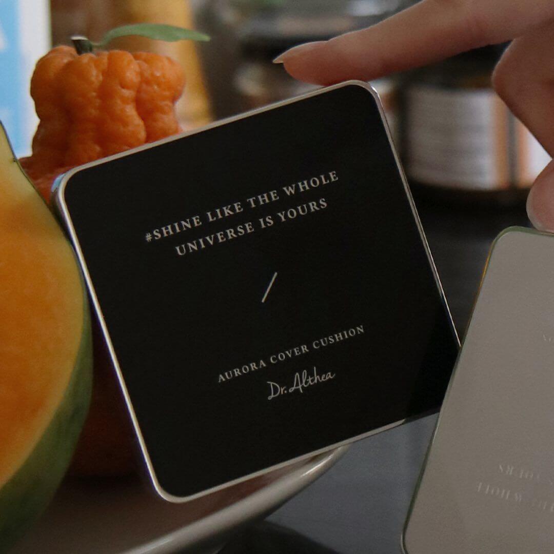Close-up of DR.ALTHEA Aurora Cover Cushion Moisture 15g with inspirational quote in elegant packaging.