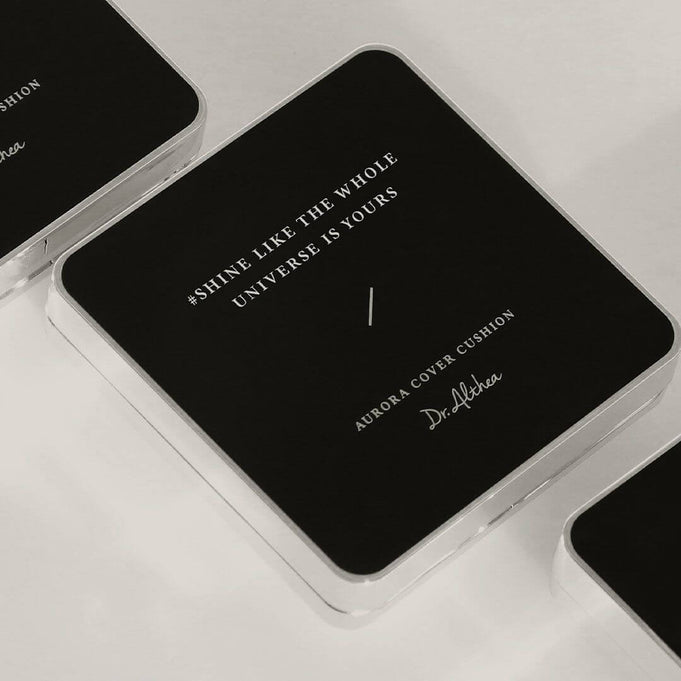 DR.ALTHEA Aurora Cover Cushion Moisture 15g in sleek black packaging with inspirational quote "Shine Like The Whole Universe Is Yours"