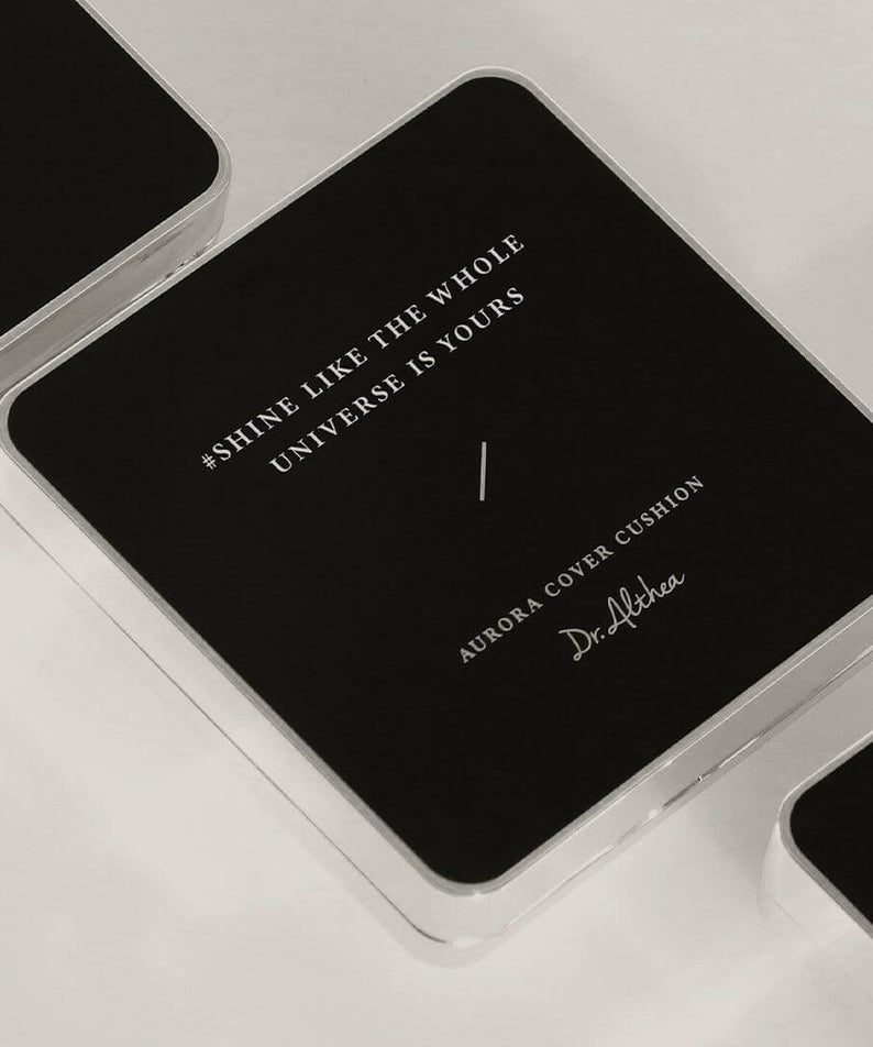 DR.ALTHEA Aurora Cover Cushion Moisture 15g in sleek black packaging with inspirational quote "Shine Like The Whole Universe Is Yours"
