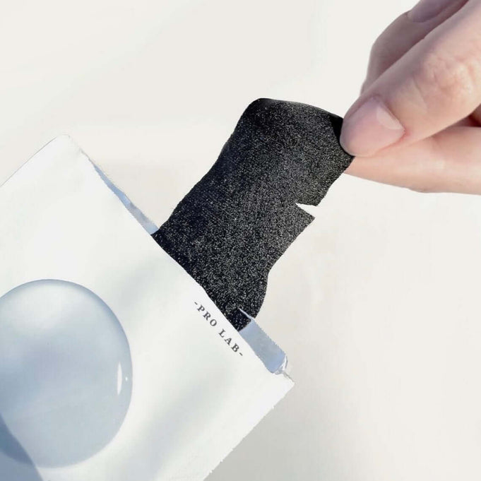 Hand holding DR.ALTHEA Blackhead Zero Two Step Nose Patch emerging from packaging