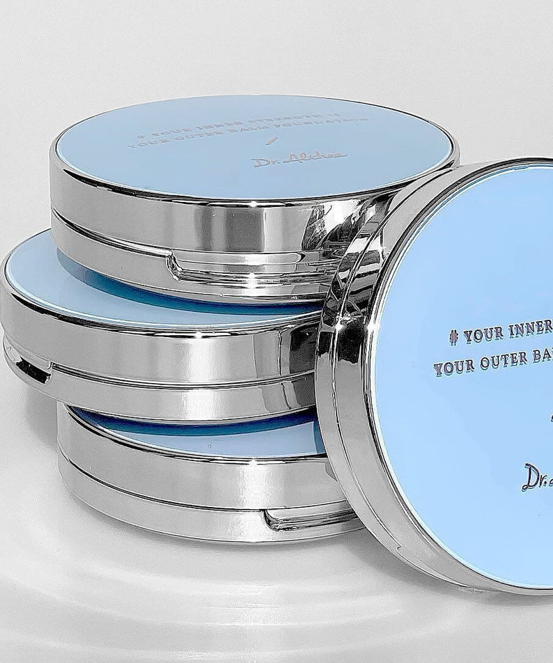 Stack of DR.ALTHEA Double Serum Night Foundation 12g compacts with blue lids and reflective borders.