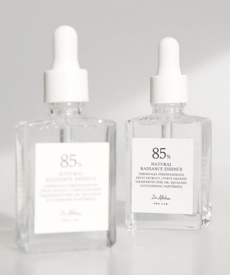 Two bottles of DR.ALTHEA Natural Radiance Essence 30ml on a white background, showcasing premium skincare product.