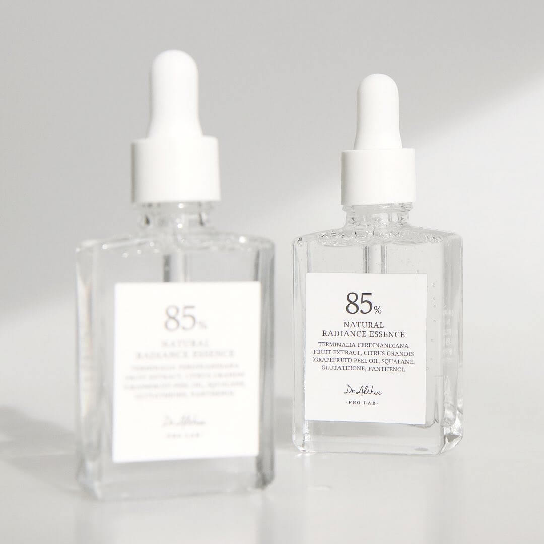 Two bottles of DR.ALTHEA Natural Radiance Essence 30ml on a white background, showcasing premium skincare product.