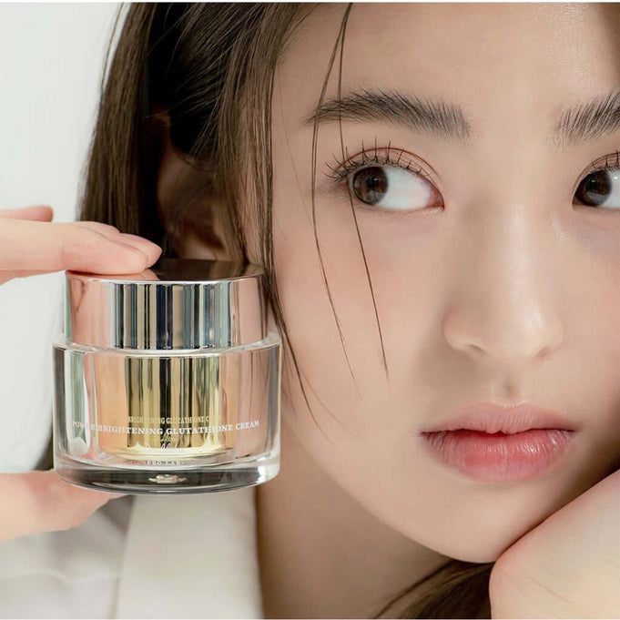 Woman holding DR.ALTHEA Niathion Cream 30ml jar with focus on skincare product.