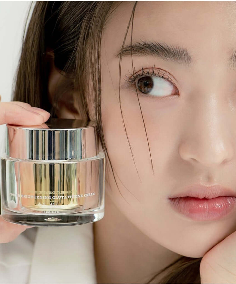 Woman holding DR.ALTHEA Niathion Cream 30ml jar with focus on skincare product.