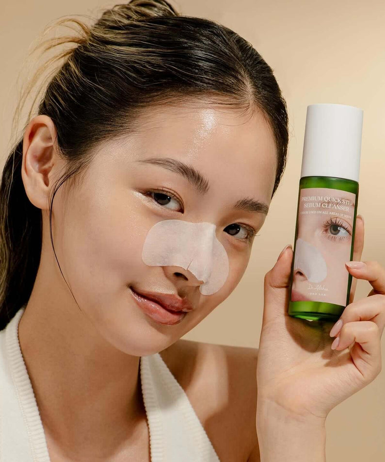 Woman holding DR.ALTHEA Premium Quick Step Sebum Cleanser 100ml with skincare patch on nose