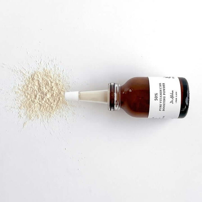 DR.ALTHEA Pure Vitamin C 50% Boosting Powder 10g bottle with powder spilled on a white surface.