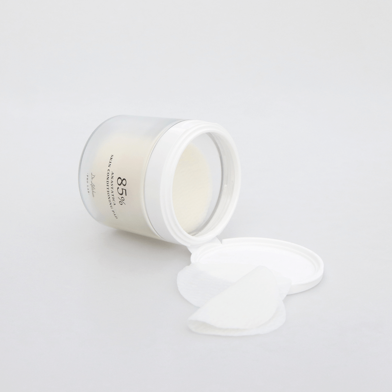 Open jar of DR.ALTHEA Resurrection SKin Conditioning Pad 170g with pads spilling out on a white surface, emphasizing skincare benefits.