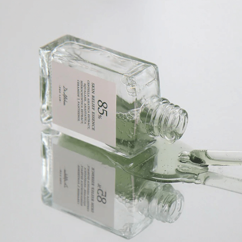 DR.ALTHEA Skin Relief Essence 30ml bottle on reflective surface, showcasing skincare product packaging.