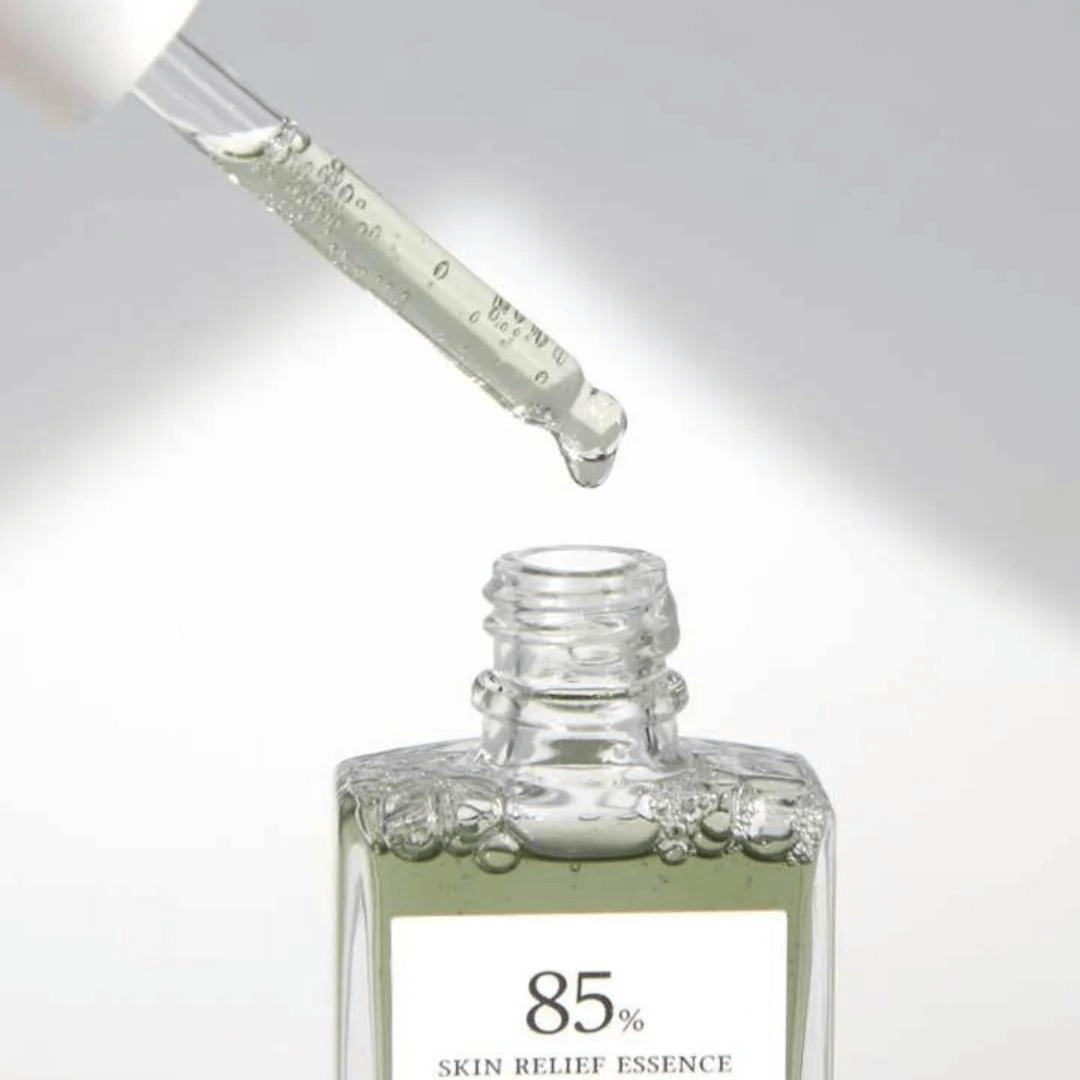Close-up of dropper dispensing DR.ALTHEA Skin Relief Essence 30ml serum into an open bottle, highlighting product texture and clarity.