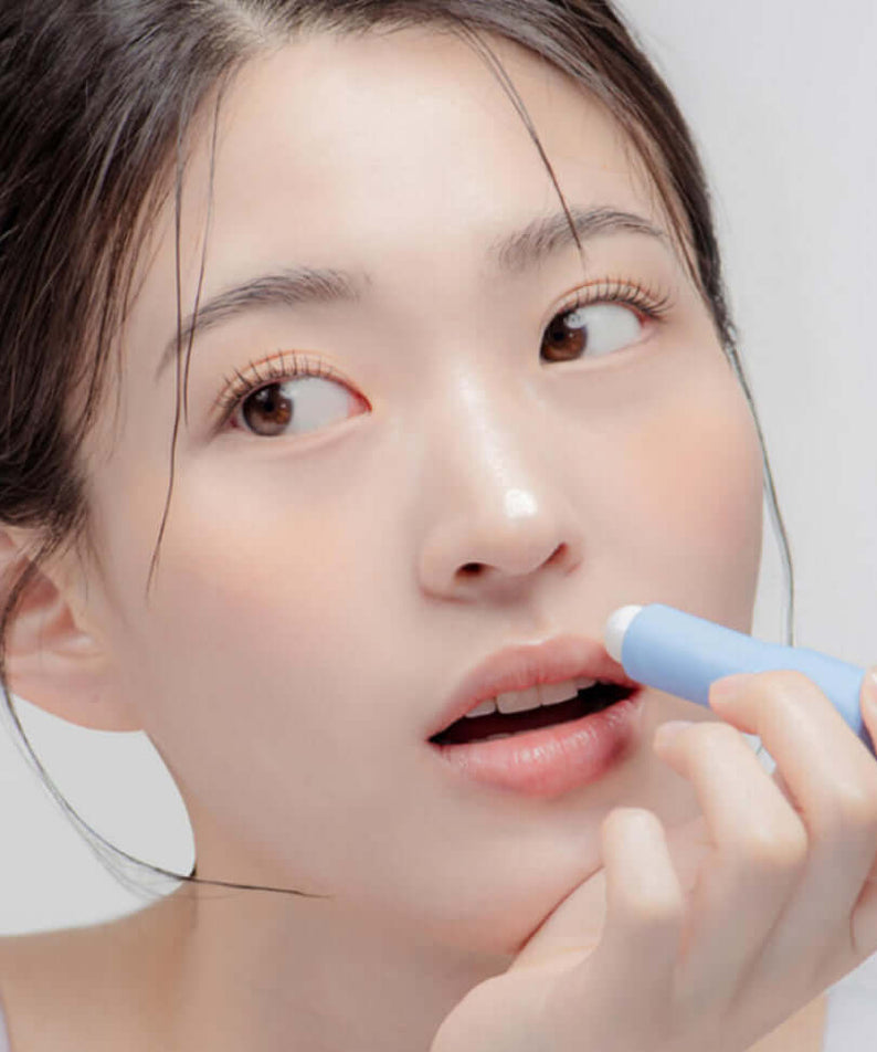 Woman applying DR.ALTHEA Soft Malting Lip Balm