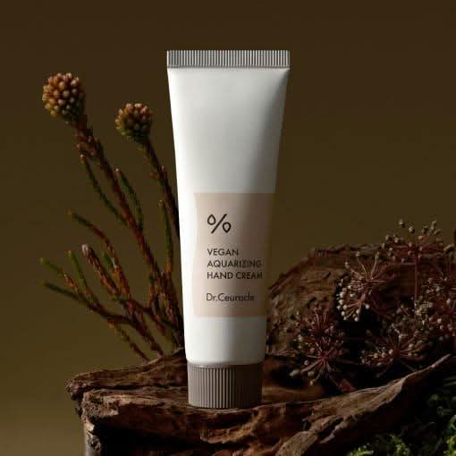 DR.CEURACLE Aqua Rising Hand cream 50ml tube displayed against a natural background with plants