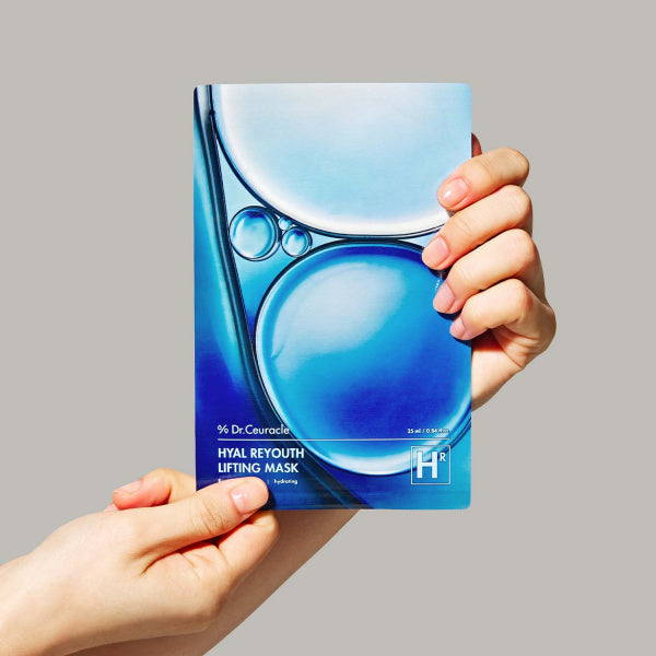 Person holding a DR.CEURACLE Hyal Reuse Lifting Mask (10EA) packaging with blue bubble design.