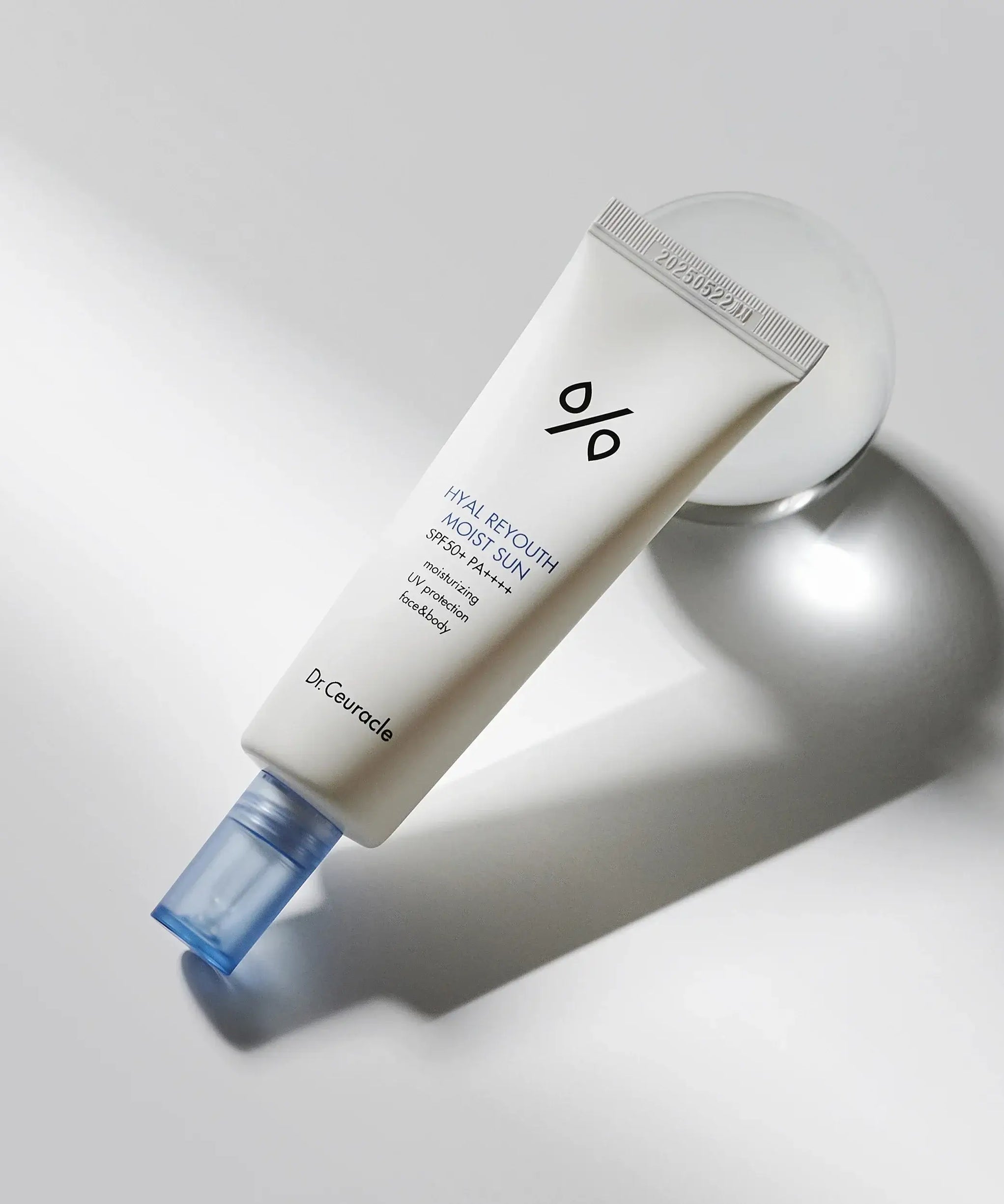 DR.CEURACLE Hyal Reyutsu Moist Sun SPF50+,PA++++ sunscreen tube on light background