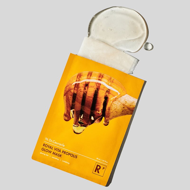 DR.CEURACLE Royal Vita Propolis Glow Mask (10EA) image showing the packaging and mask essence on a gray background.