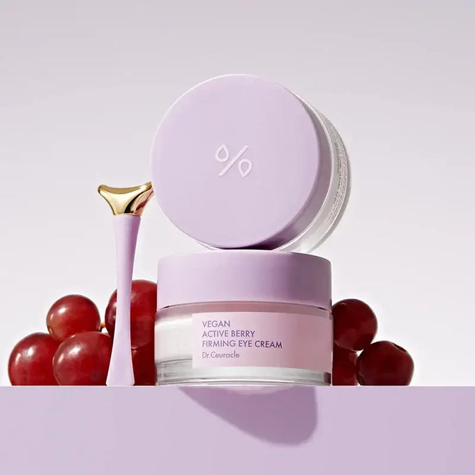 DR.CEURACLE Vegan Active Berry Firming Eye Cream with purple packaging, surrounded by berries and skincare applicator.