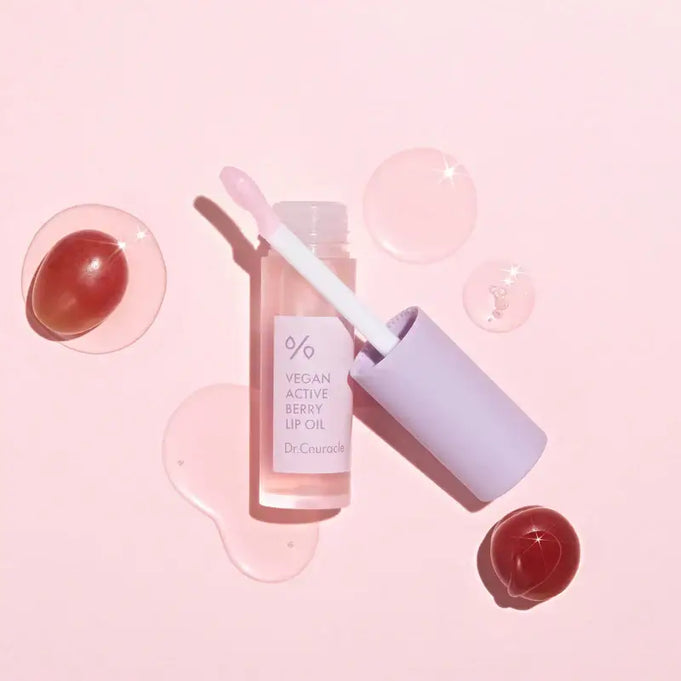 DR.CEURACLE Vegan Active Berry Lip Oil displayed with pink background and glossy texture