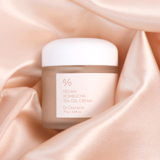 DR.CEURACLE Vegan Kombucha Tea Gel Cream 75g on silky rose-gold fabric