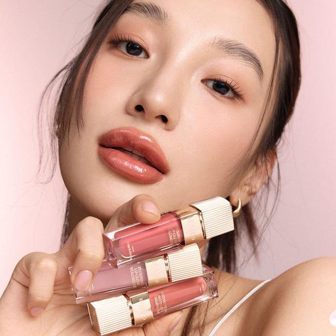 Model showcasing D'ALBA Plumping Lip Glow Mood Volumizer 5ml with pink and nude shades, highlighting its plumping effect and glossy finish.