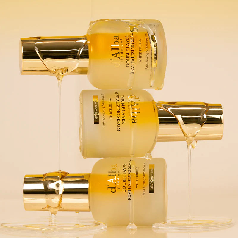 Three bottles of D'ALBA Vegan Double Serum 30ml stacked with honey drizzling down, highlighting its luxurious and nourishing formula.