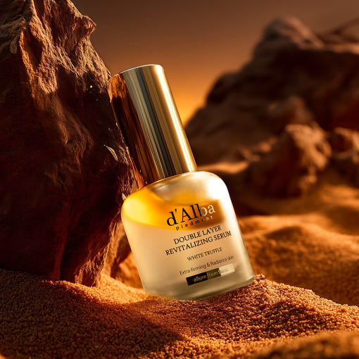 D'ALBA Vegan Double Serum 30ml on a sandy landscape with rocks, emphasizing its premium skincare qualities and ethical formulation.