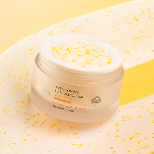 D'ALBA Vita Toning Capsule Cream Complex 55g in a jar on a yellow background, showcasing its moisturizing and brightening properties.