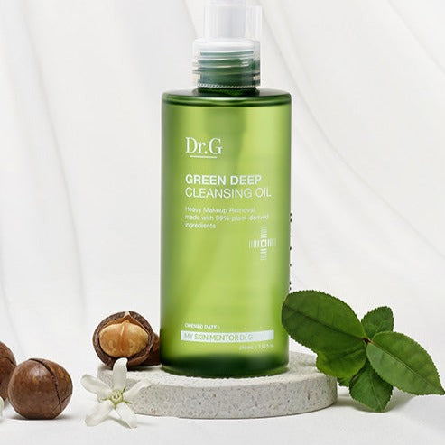 Dr.G Green Depp Cleansing Oil 210ml with plant ingredients on display with nuts and leaves.